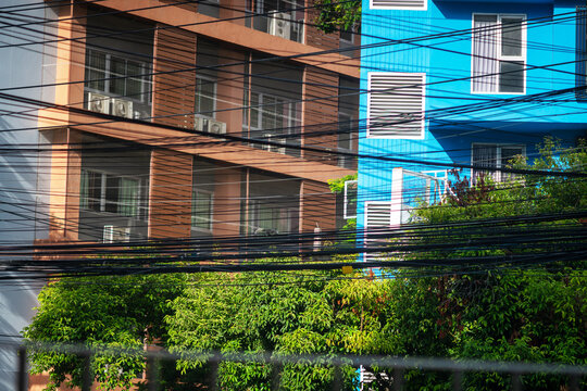 Bright Blue and Brown Apartment Building with Green Trees