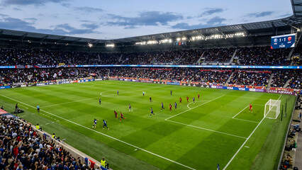Aerial drone view of a vibrant green professional soccer stadium field © Rifqi