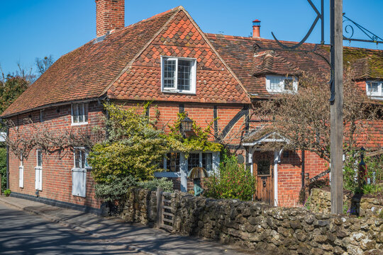 A generic brick cottage in the countryside of the UK