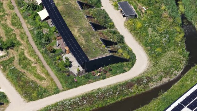 Sustainable earthship homes with green roofs aerial view