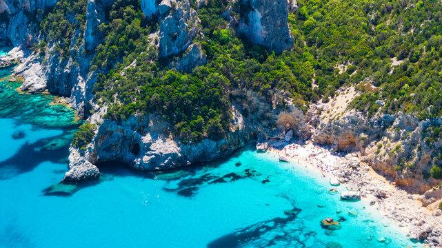 Aerial drone view of Cala Goloritz&egrave; on the Baunei coast, Gulf of Orosei, Sardinia. Iconic limestone pinnacle, turquoise waters, white cliffs, and pristine Mediterranean scenery.
