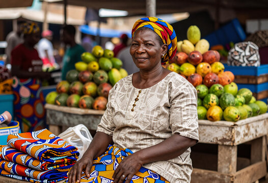 Nigerian woman selling colorful fabrics at Lagos market