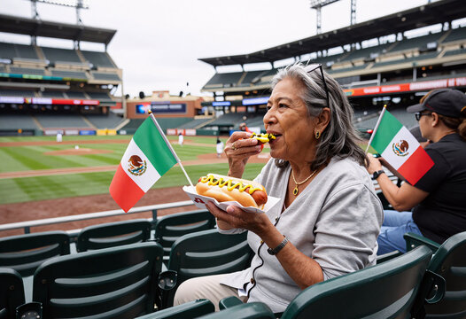 Latin Grandmother Eating Hot Dog at Baseball Game
