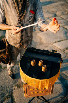 Street Performer Shows Magic Tricks With Red Ball and Cups