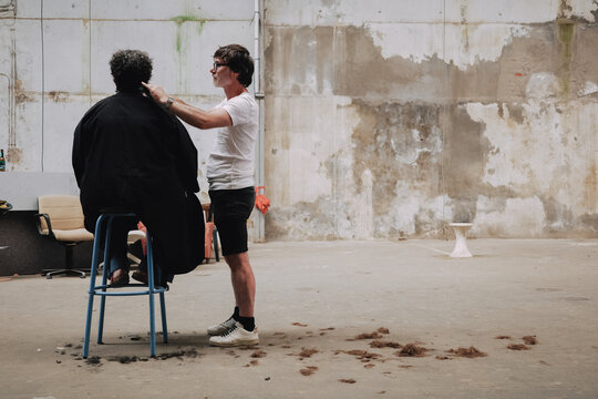 Barber Cuts Hair in an Empty loft studio