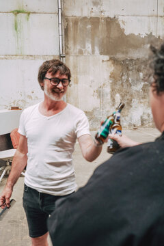 Friends Toasting Beer Bottles 