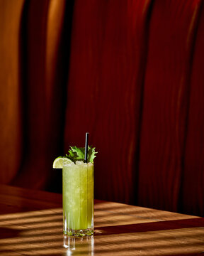Green Cocktail With Lime in Moody Restaurant Light