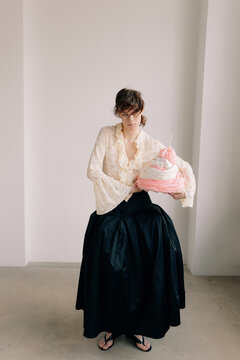 Full body editorial portrait with abstract pastel textile object