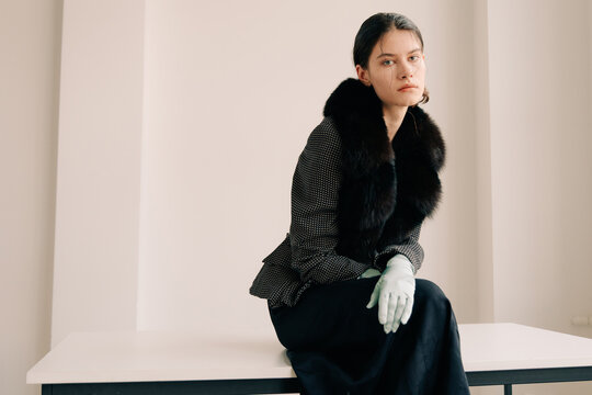 Minimal luxury fashion portrait with fur collar and gloves