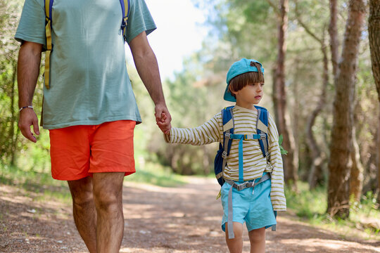 Father and son hiking in the forest
