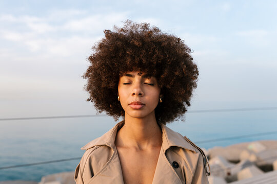 Woman with closed eyes practicing mindfulness outdoors