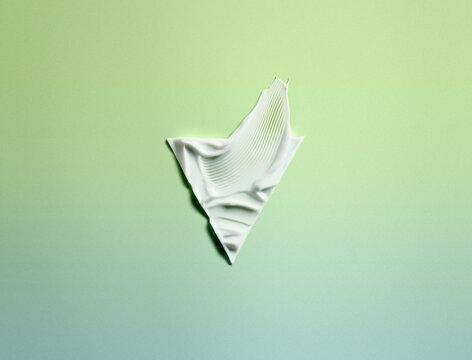 Moisturising cream in a triangular shape against a green background 