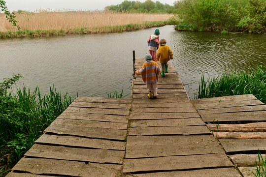 Children Walking Toward a Quiet Lake