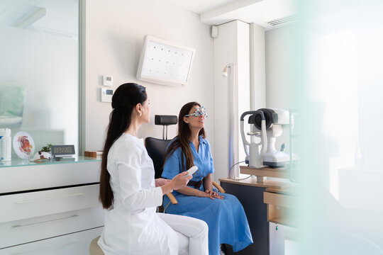 Woman Undergoes Eye Exam in Modern Clinic With Specialist Present