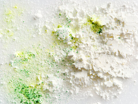 White powder with green pigment