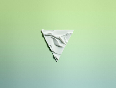 Moisturising cream in a triangular shape against a green background 