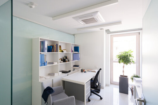 Office Space With Desk, Shelves, and Large Window