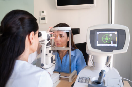 Patient Receives Eye Exam at Clinic With Optometrist Help