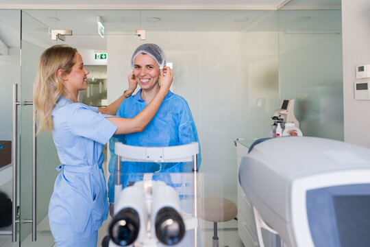 Nurse Helps Patient Prepare for Eye Surgery in Clinic