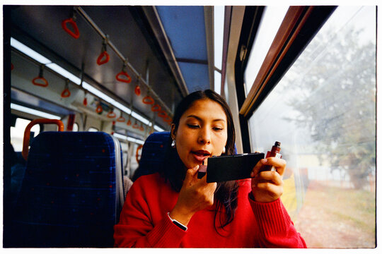 Latina woman doing her makeup