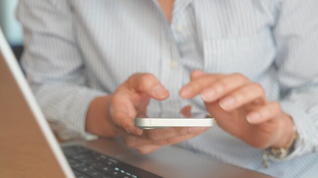 Close up Professional using Smartphone and Laptop for Business Communication,Mobile Workflow,Digital Productivity.Technology concept Remote work,Online Services,Task Management,Connectivity Workplace