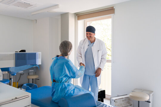 Doctor and Patient Shaking Hands In Medical Office