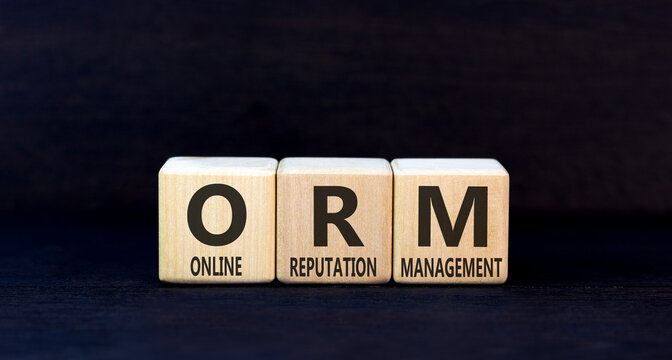 ORM online reputation management symbol. Concept words ORM online reputation management on beautiful wooden blocks. Beautiful black background. Business ORM concept. Copy space.