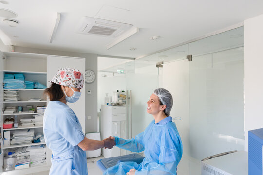Healthcare Worker and Patient Handshake in a Medical Office