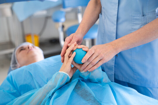 Patient Holds Stress Ball During Surgery in Clinic
