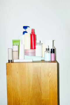 Wooden table full of versatile cosmetic beauty makeup products 