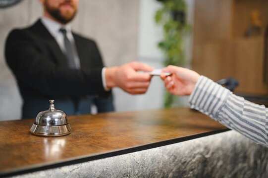 Hotel guest receiving key card at reception desk