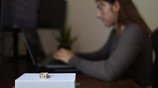 Young woman working remotely on freelance technology projects developing digital skills and building career while using laptop in home office