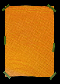 Blank Orange Paper Poster with Green Tape Isolated on Black Background