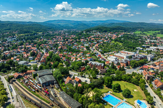 Drone view of Wernigerode with Harz Narrow Gauge Railways depot, Hospital, public swimming pool, Hasserode district and Brocken mountain, Harz Region, Saxony Anhalt, Germany