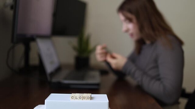 Cloud security concept as woman examines encrypted security token for protected access to cloud storage highlighting authentication data protection and cybersecurity