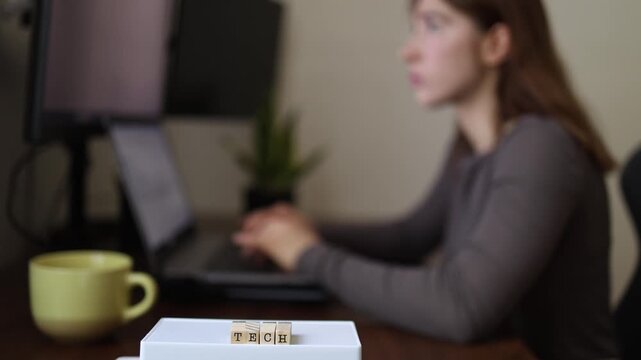 Technology overload concept as woman pauses to think during computer work highlighting digital fatigue mental focus problem solving and modern office workflow
