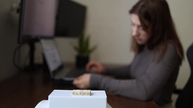 Cloud storage security concept as young woman accesses online files through laptop highlighting remote data management digital workspace and modern cloud computing