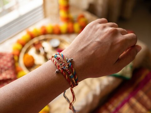 Colorful rakhi thread tied on brother wrist for Raksha Bandhan celebration