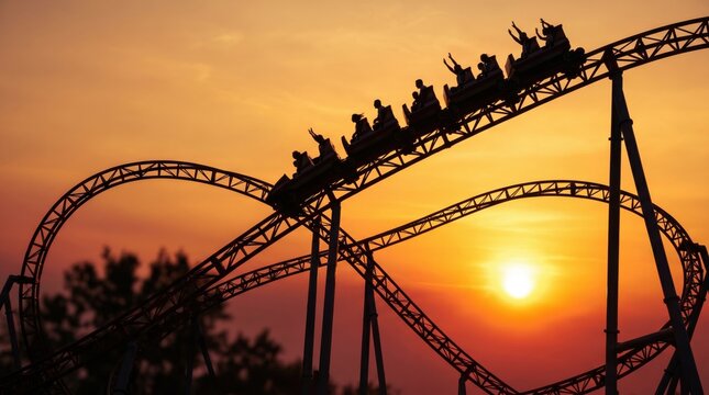 Silhouette of a rollercoaster train with people going down track at sunset, roller coaster day background
