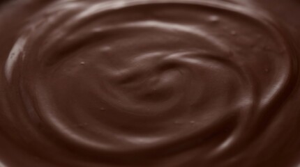 Naklejka premium Smooth chocolate texture with swirly pattern on melted chocolate surface