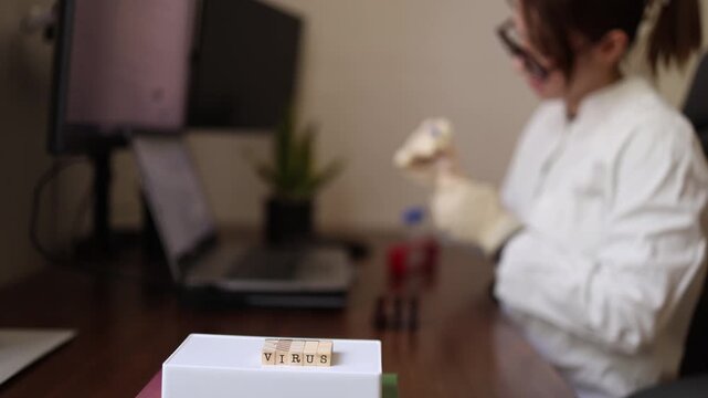 Medical scientist evaluates biological samples while investigating a newly emerging virus Combining laboratory findings with digital research to assess potential threats
