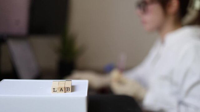 Laboratory researcher records experiment data and observations while working at computer Scientific analysis documentation and research workflow
