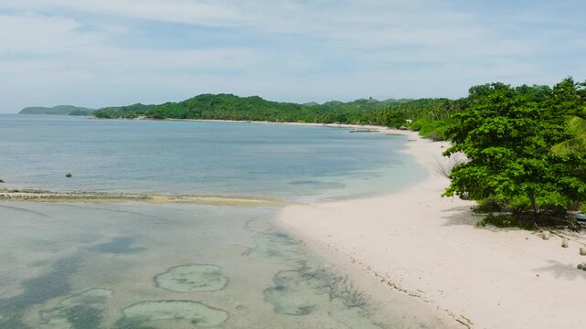 Transparent sea water and waves on white sand beach. Santa Fe, Tablas, Romblon. Philippines.