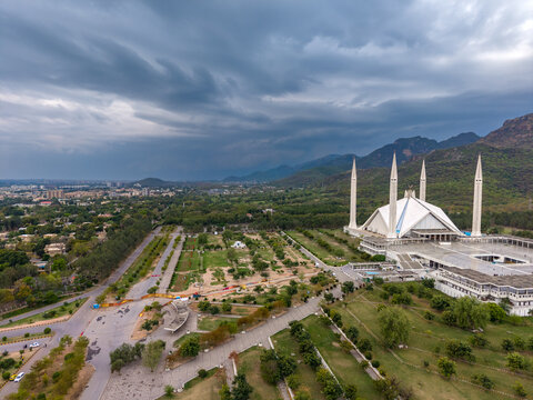 Aerial view of Faisal Masjid with its iconic minarets and white structure set against the backdrop of the Margalla Hills in Islamabad, Islamabad Capital Ter, Pakistan.