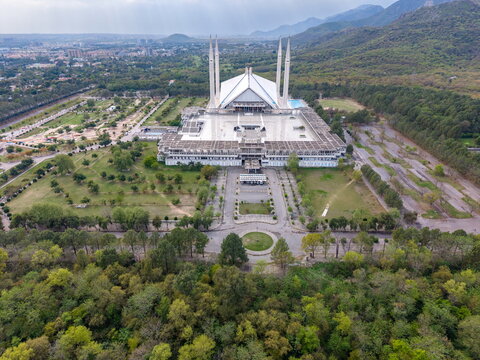 Aerial view of Faisal Masjid surrounded by lush green gardens and trees at the foothills of the Margalla Hills in Islamabad, Islamabad Capital Ter, Pakistan.