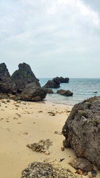 Deserted Beach with Small Stones and Big Rocks