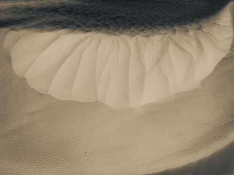 Aerial view of the sand dunes at Conspicuous Cliff, showing intricate wind-swept patterns and textures in the sand in Nornalup, Western Australia, Australia.