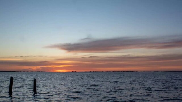 4K Time-lapse of a Vibrant Sunrise and Clouds Over the Ocean at Fort De Soto
