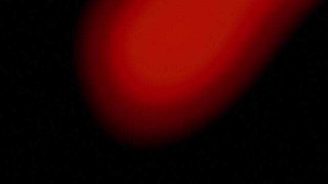 Abstract light leak effect glowing on black background. Dynamic orange and red flares transition overlay
