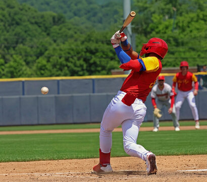 baseball player hitting a pitch